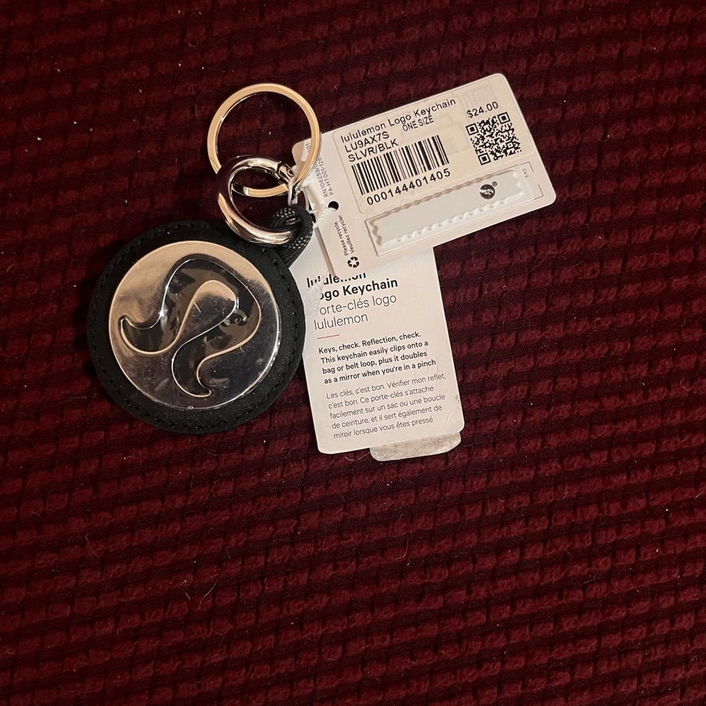 Lululemon logo keychain. Glare is due to protective cover still being on.